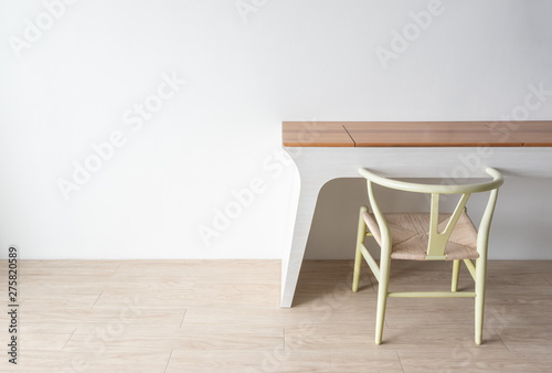 Minimalist architect designer concept with green classic chair and modern table on wooden floor with white wall background.