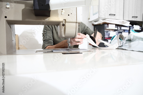 woman hands sewing machine, close up