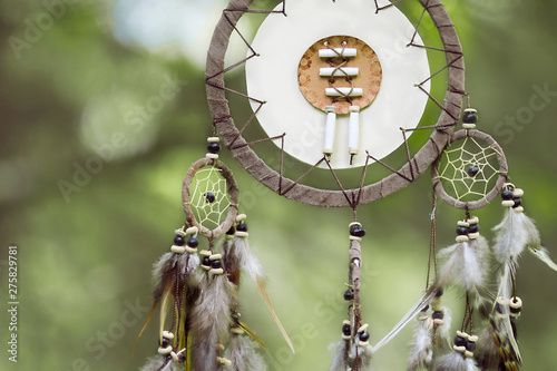 A dream catcher hanging from a tree