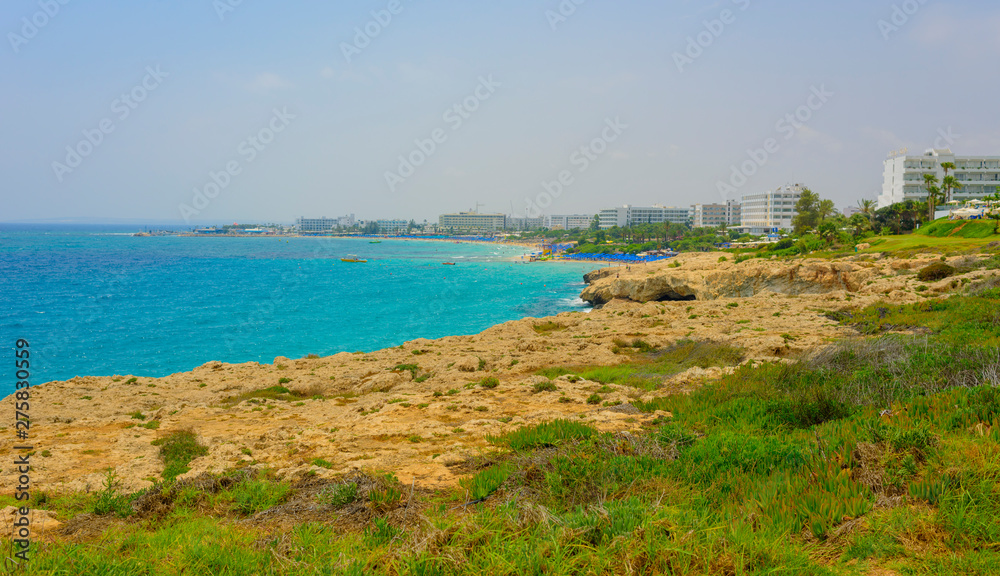 Panoramic view of Ayia Napa coast, Cyprus with blue sea and yellow-black rocks Panoramic view of Ayia Napa coast, Cyprus with blue sea and yellow-black rocks