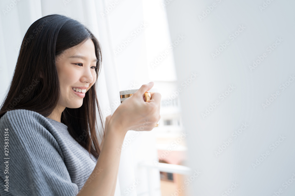 Portrait Asian woman relaxing with coffee at home Portrait Asian woman relaxing with coffee at home