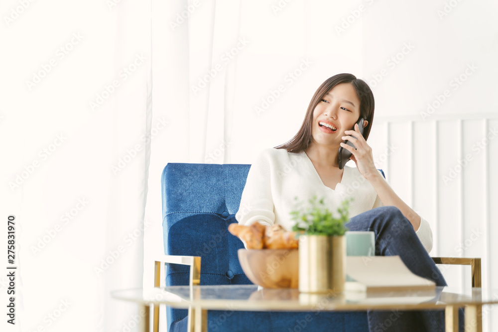 Young Asian woman using phone talking happy and smile.