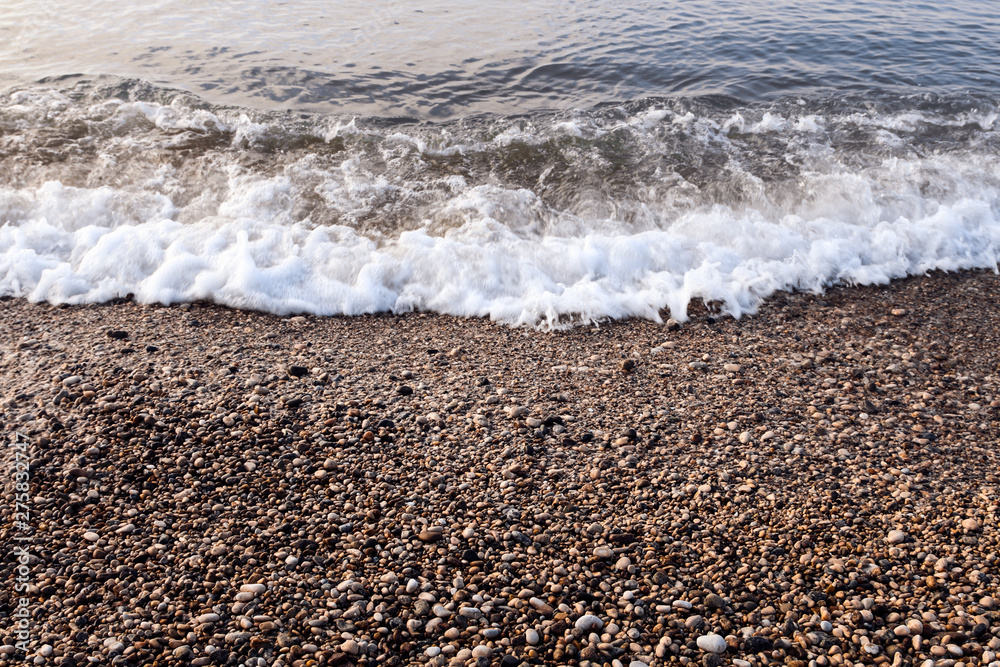sea waves with pebbles and foam sea waves with pebbles and foam