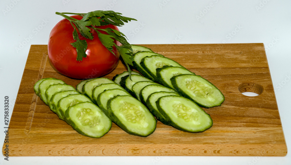 Cucumber, tomato, dill, on cutting Board Cucumber, tomato, dill, on cutting Board