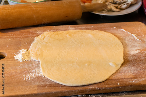 Pizzza bread laying on a wooden table
