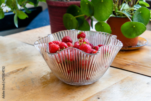 Fresh strawberries in a bowl on a table