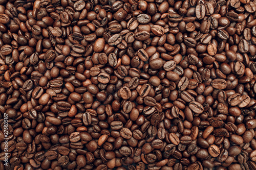 Roasted coffee beans brown seeds texture background wallpaper.