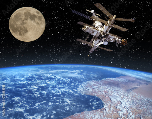 Fototapeta Naklejka Na Ścianę i Meble -  Moon and space station flying near. The elements of this image furnished by NASA.