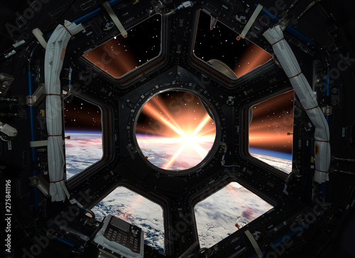 Earth in window of spaceship. Elements of this image furnished by NASA.
