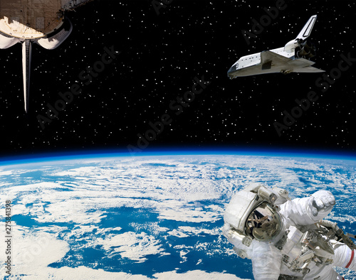 Astronaut and spaceships against earth. The elements of this image furnished by NASA.