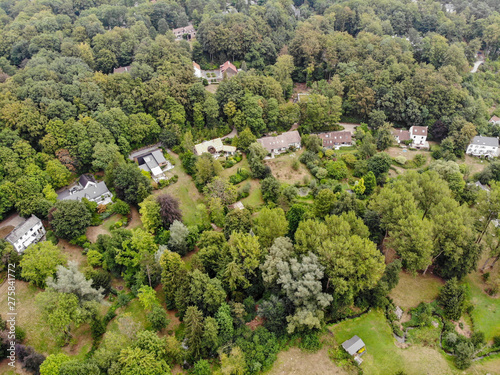 Aerial view of country side area in Walloon Brabant, Belgium, Luxury villas with garden surrounded by forest during autumn season © Unwind