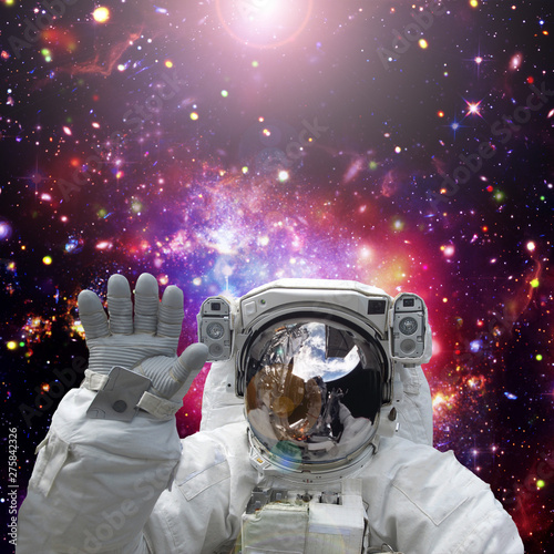 Astronaut waves. The elements of this image furnished by NASA.