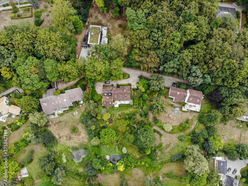 Aerial view of country side area in Walloon Brabant, Belgium, Luxury villas with garden surrounded by forest during autumn season