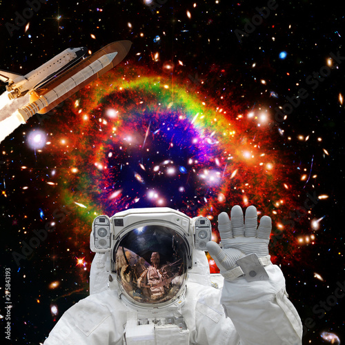 Astronaut posing. Rocket on the backdrop. The elements of this image furnished by NASA.