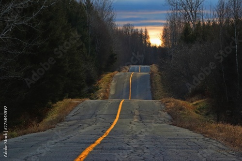 Sunset light on bumpy country road photo