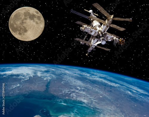 Fototapeta Naklejka Na Ścianę i Meble -  Moon and space station flying near. The elements of this image furnished by NASA.