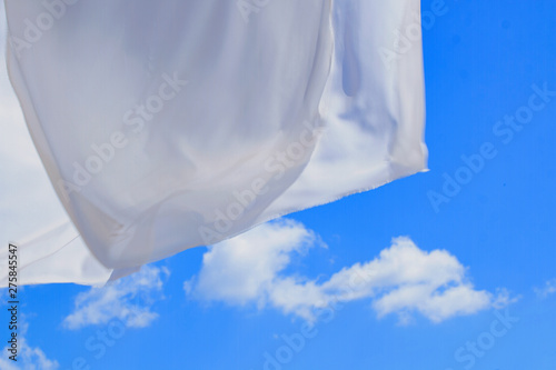 light airy white fabric against a blue sky
