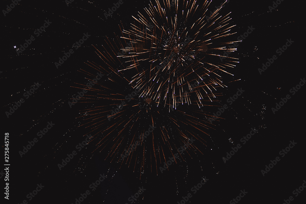 Festive multicolored salute on the background the dark night sky. Salute from the pyrotechnics.