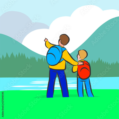 Father and son tourists with backpacks are standing on the green grass and admire the beautiful scenery of the wild nature: river, forest and mountains with clouds.
