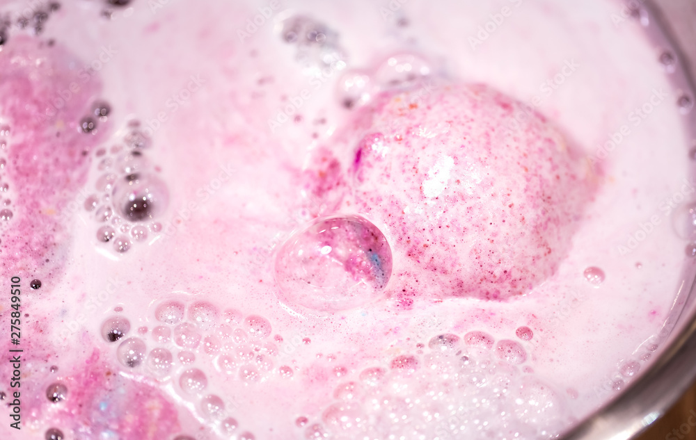 Fototapeta premium The bright bath bomb dissolves in water .