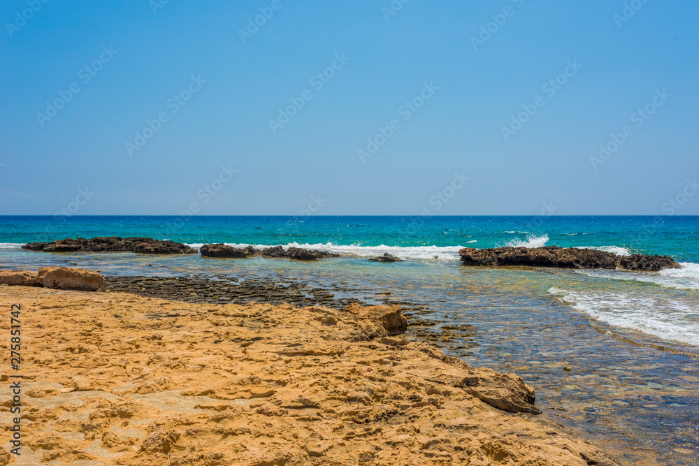  pristine seascapes with crystal clear blue water and yellow rocks in Ayia Napa, Cyprus