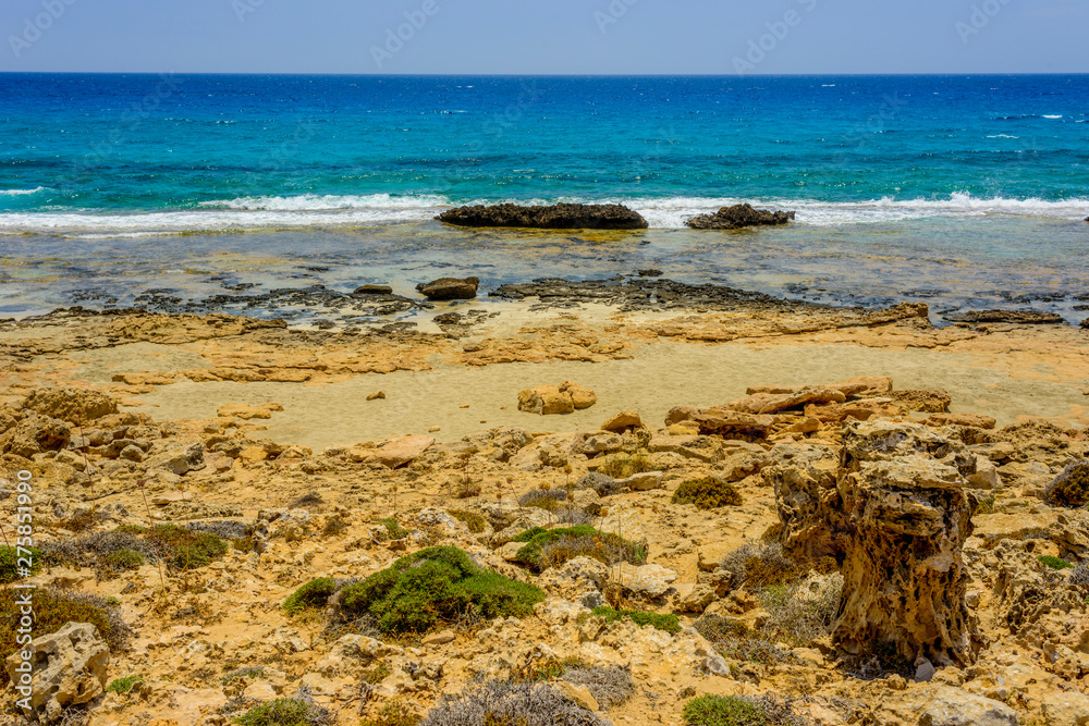 pristine seascapes with crystal clear blue water and yellow rocks in Ayia Napa, Cyprus pristine seascapes with crystal clear blue water and yellow rocks in Ayia Napa, Cyprus