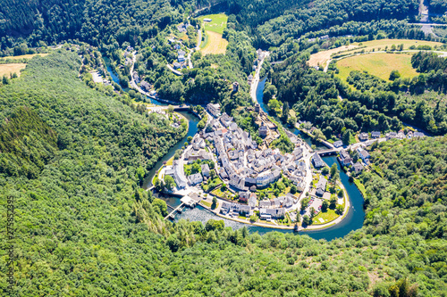 Aerial view of Esch-sur-Sure, medieval town in Luxembourg, dominated by castle, canton Wiltz in Diekirch. Forests of Upper-Sûre Nature Park, meander of winding river Sauer, near Upper Sauer Lake photo