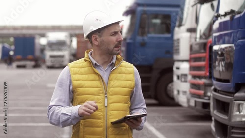 Trailer driver with hard hat and safety vest. Close up portrait of worker photo