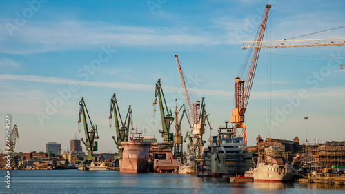 Stampa su tela View of the shipyard with historical cranes and ships in the industrial part of the city Gdansk/Poland
