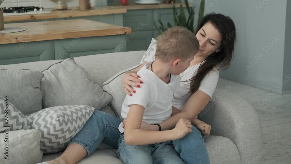 Pretty Mom And Son Hugging At Bed With Pillows Happy Motherhood pretty-mom-and-son-hugging-at-bed-with-pillows-happy-motherhood