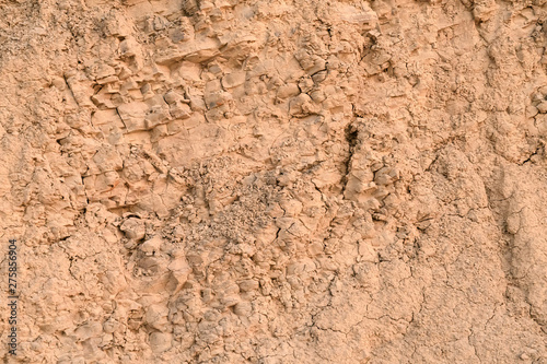 Wall of clay with a huge amount of small crumbs