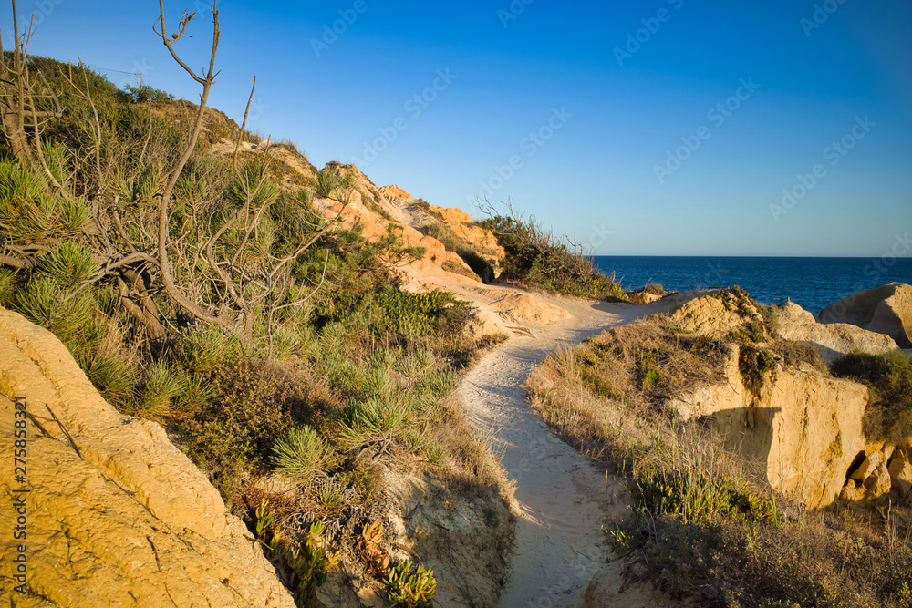Walking path on cliff along Praia da Galé,  Albufeira, Portugal