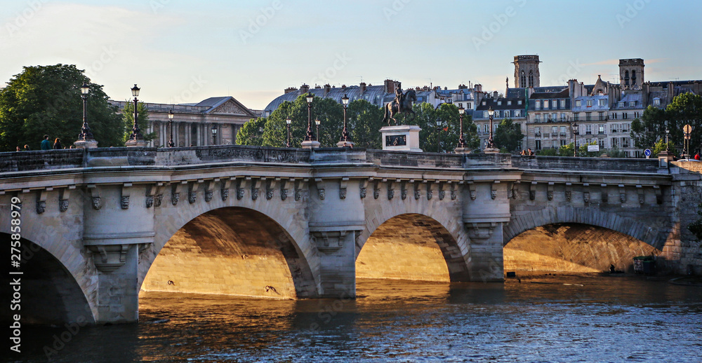 Pont Neuf Bridge in Paris as the sun is setting. 