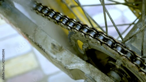 close-up, process of spraying lubricant onto a moped chain with spray from a balonchik photo