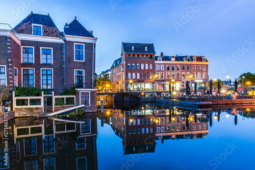 Traditional Dutch culture houses and canal during dusk in Leiden, Holland photo