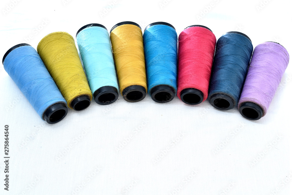 Colorful sewing thread reels on white background. Colorful sewing thread reels on white background.