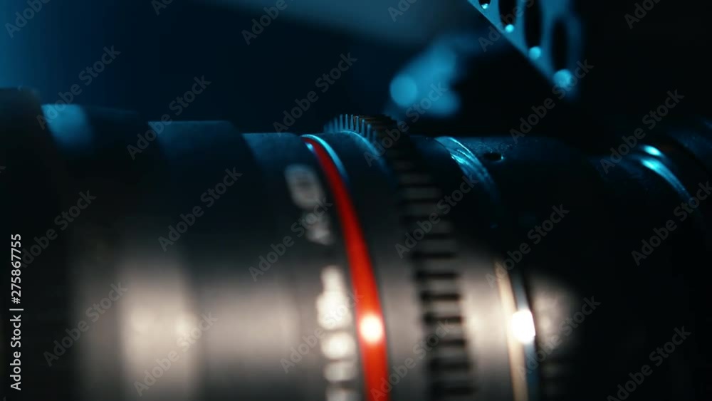 Rotating unrecognizable mirrorless camera with lens attached, studio shot, cinematic blue backlight, Perfect introductory shot for tv or for a shops product advertisement