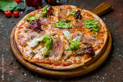 Pizza with Parma ham on the board
