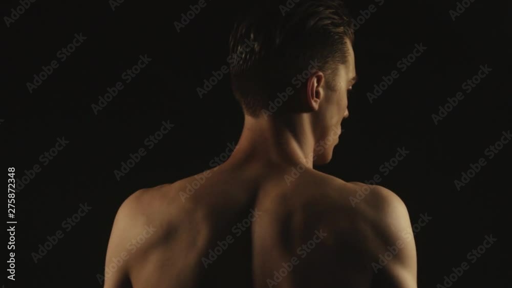 Sexy sport stripped guy in water drops with smoke on isolated black background Sexy sport stripped guy in water drops with smoke on isolated black background