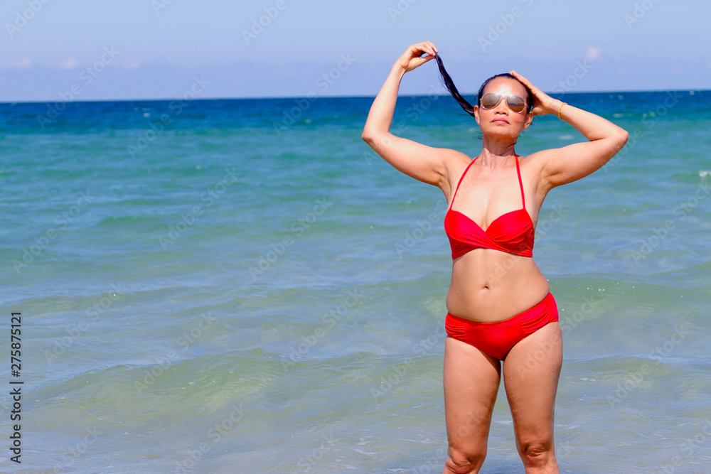 Woman show shape sexy with red bikini on beach