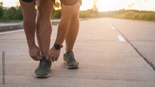 Men are tying shoes to prepare for running.in evening