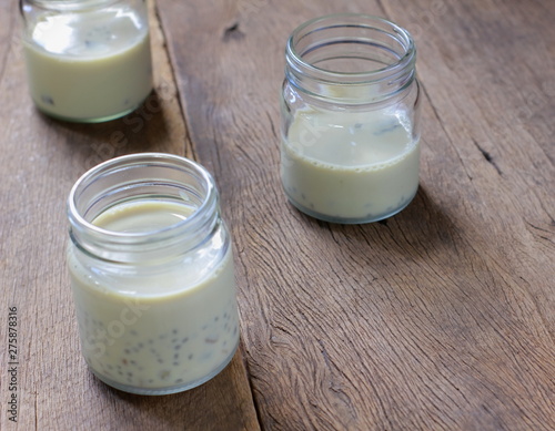 black sesame soy milk in glass on wooden photo