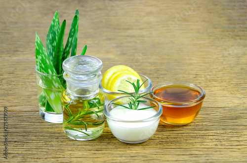 Honey, lemon, rosemary leaves, greek yogurt, aloe vera leaves and essential oil for homeopathy remedy.