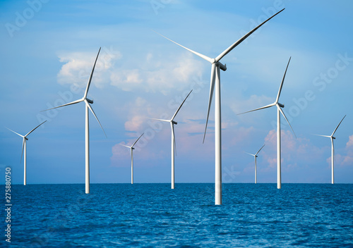Wind turbine farm power generator in beautiful nature landscape for production of renewable green energy is friendly industry to environment. Concept of sustainable development technology.