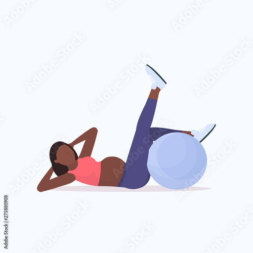 pregnant woman doing exercises with gymnastic ball african american girl working out fitness pregnancy healthy lifestyle concept full length flat