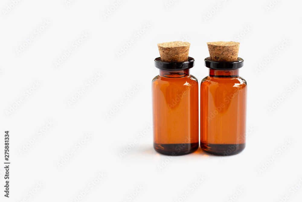 Brown bottle with essential oils on white Brown bottle with essential oils on white