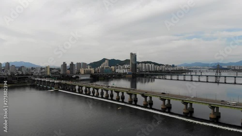 Wallpaper Mural Aerial view of Han river in Seoul, South Korea. Aerial view of bridge on top water with car moving and city with mountain on the background Torontodigital.ca