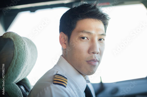 Captain male pilot portrait, driving an airplane. © globalmoments