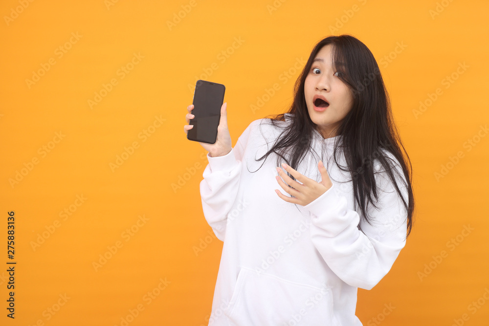 happy excited glad to receive text message informing about salary, rejoices good news, stares at mobile phone, actively from happiness, Beautiful Asian models over pink background for advertising c happy excited glad to receive text message informing about salary, rejoices good news, stares at mobile phone, actively from happiness, Beautiful Asian models over pink background for advertising c