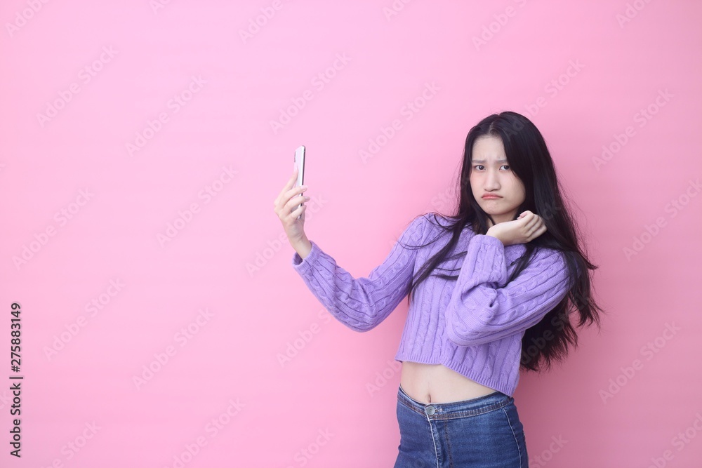 happy excited glad to receive text message informing about salary, rejoices good news, stares at mobile phone, actively from happiness, Beautiful Asian models over pink background for advertising c happy excited glad to receive text message informing about salary, rejoices good news, stares at mobile phone, actively from happiness, Beautiful Asian models over pink background for advertising c